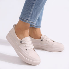 Ursula Women's Cushioned Lace-Up Sneakers worn by model, white studio background